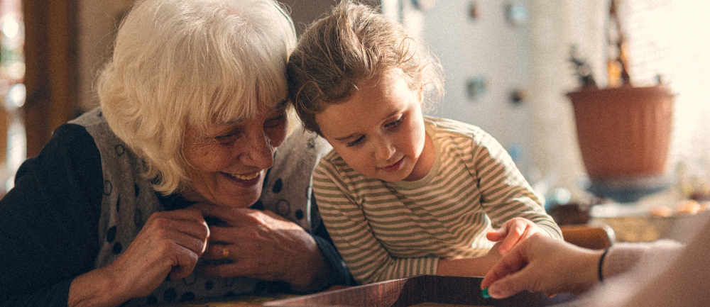 Woman playing board game with grand-daughter